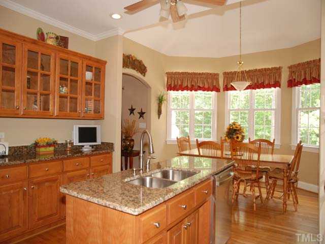 1005 Farnsworth Road Wake Forest, NC 27587 - Photo 7 of 25 The cook friendly kitchen offers granite countertops, crown molding, stainless steel appliances and plenty of counterspace and cabinets.