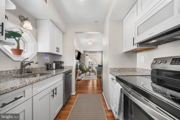 a kitchen with granite countertop stainless steel appliances and sink