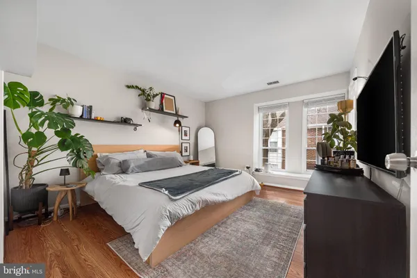 a bedroom with a bed furniture and a flat screen tv