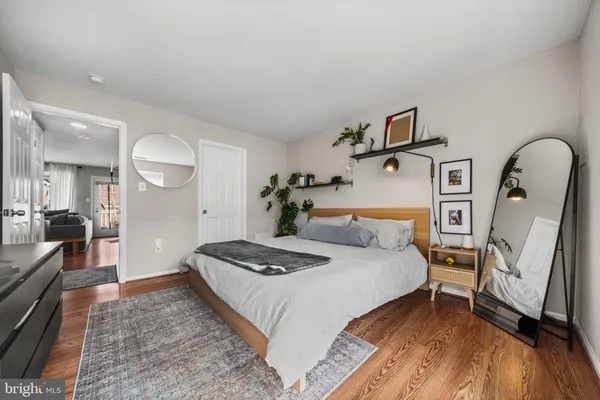 a bedroom with bed and wooden floor