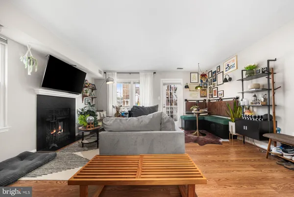 a living room with furniture a flat screen tv and a fireplace
