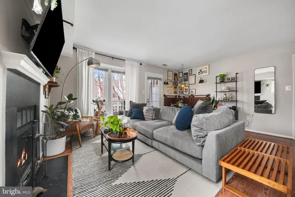 a living room with furniture a rug and a flat screen tv
