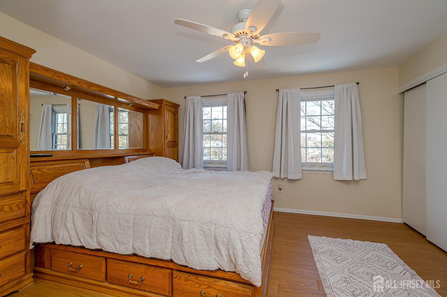 70-10 Prospect Street, Unit 10 Metuchen, NJ 08840 - Photo 16 of 20 a bedroom with a bed and a chandelier