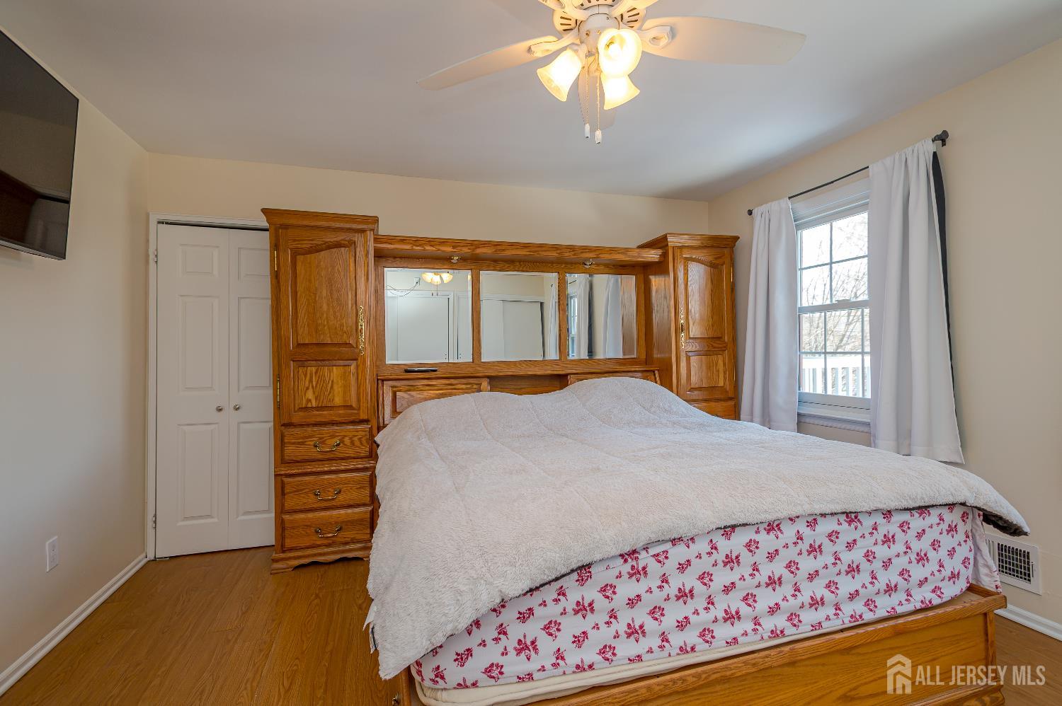 70-10 Prospect Street, Unit 10 Metuchen, NJ 08840 - Photo 17 of 20 a bedroom with a large bed and a chandelier