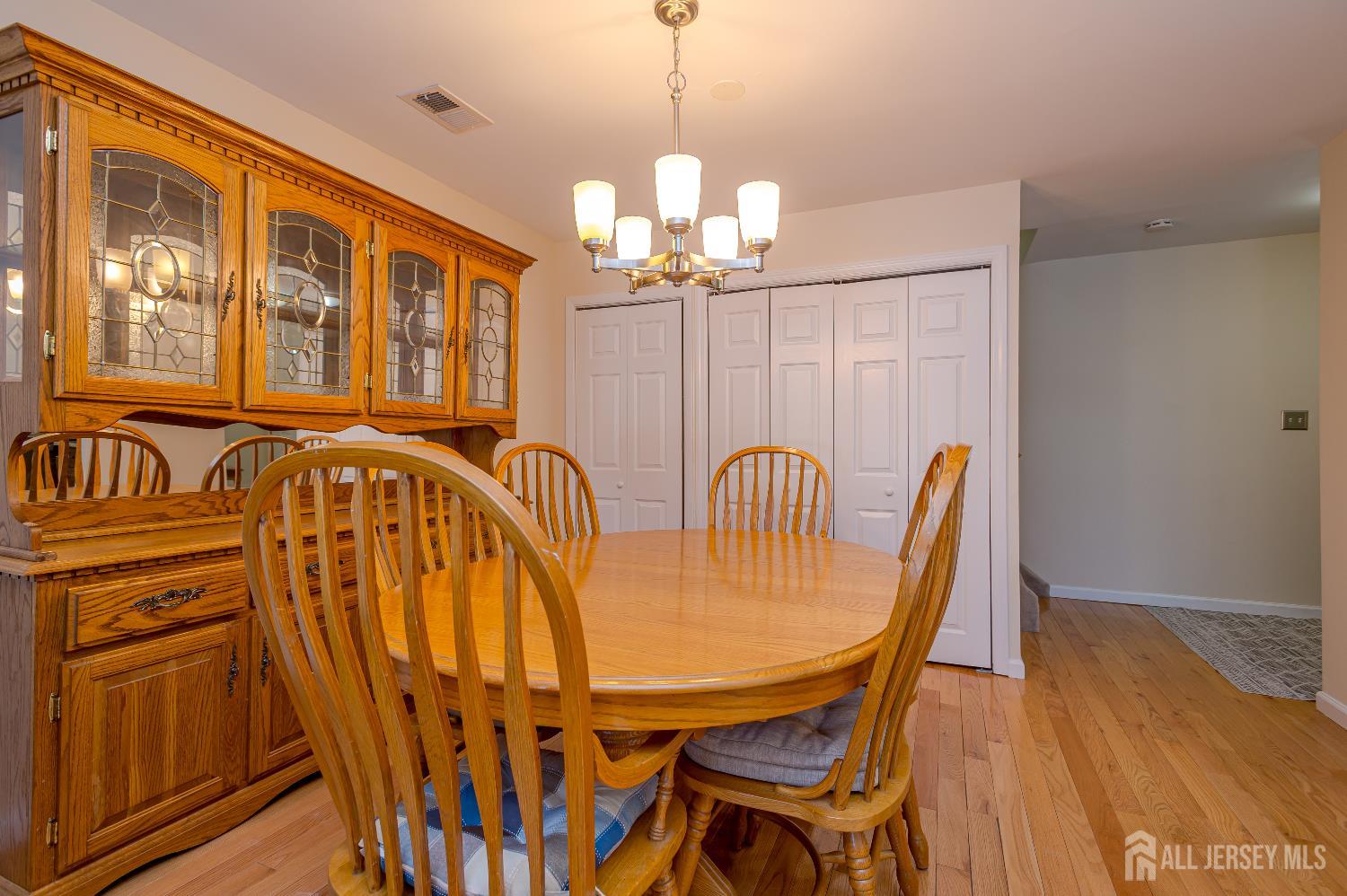 70-10 Prospect Street, Unit 10 Metuchen, NJ 08840 - Photo 7 of 20 a view of a dining room with furniture wooden floor and chandelier