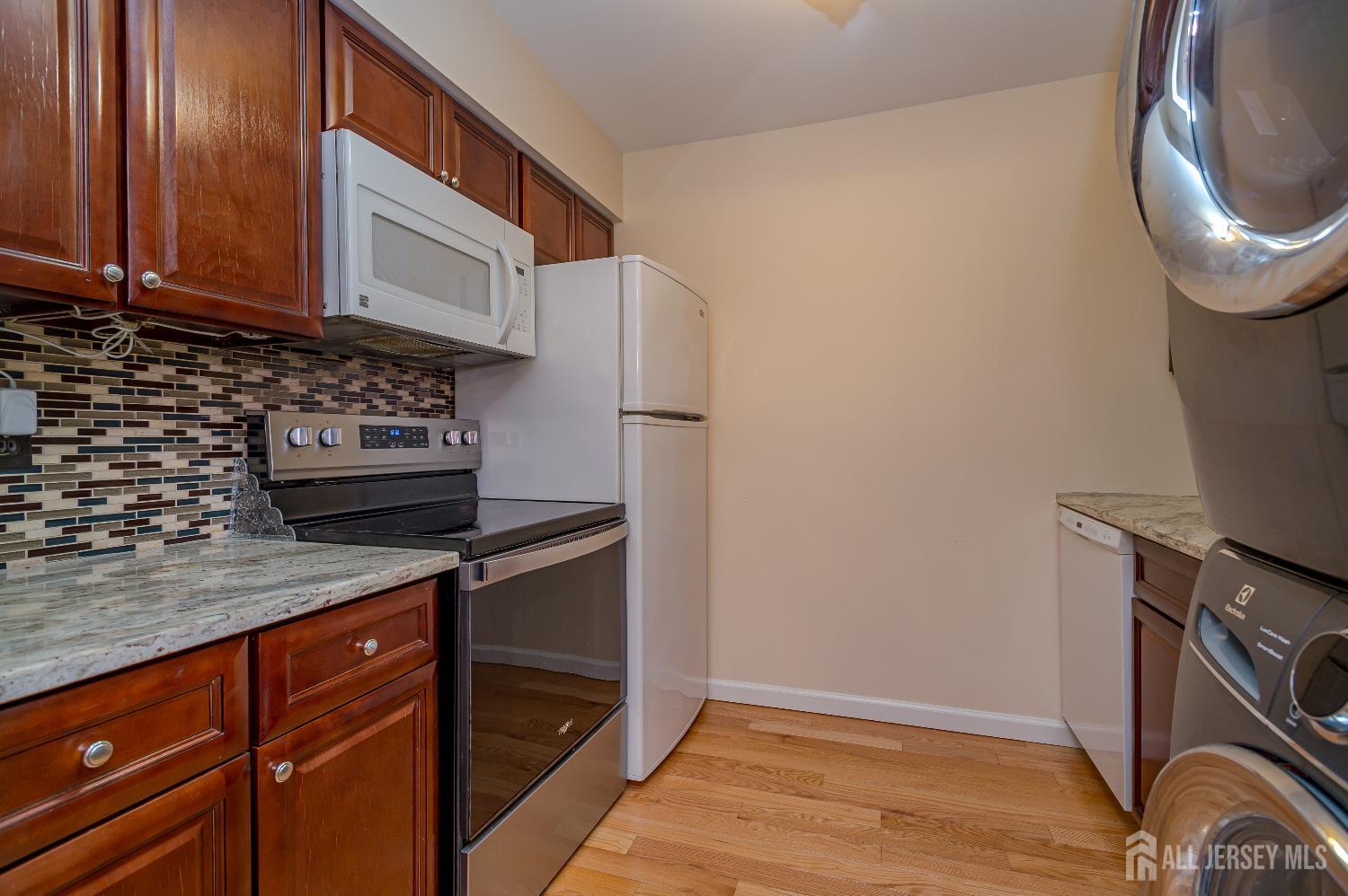70-10 Prospect Street, Unit 10 Metuchen, NJ 08840 - Photo 8 of 20 a kitchen with stainless steel appliances granite countertop a stove a sink and a microwave