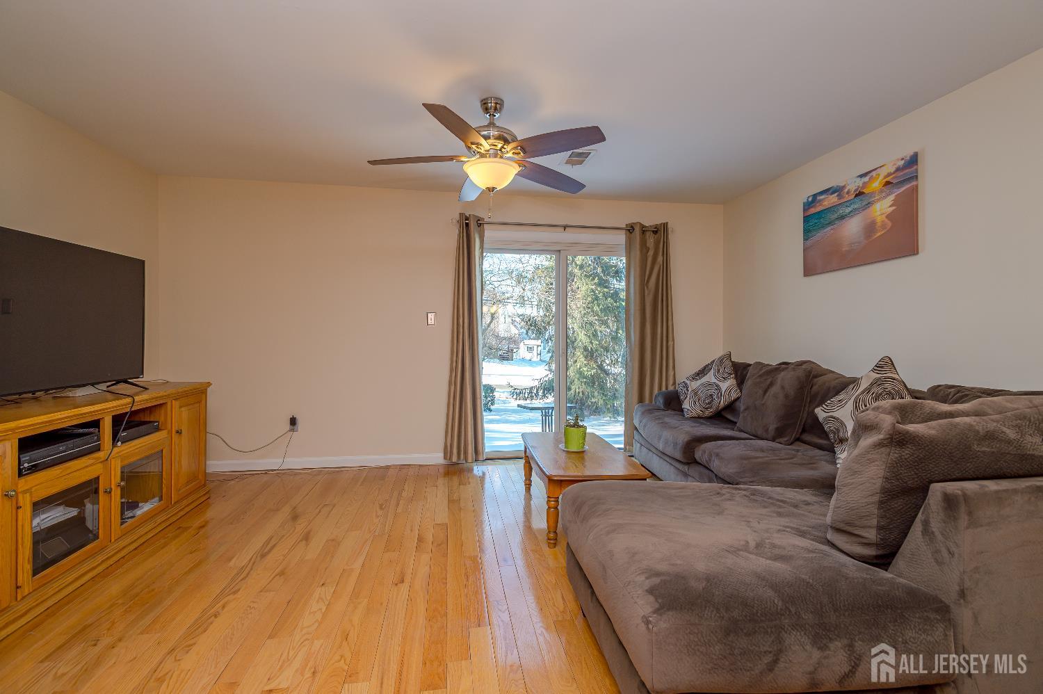70-10 Prospect Street, Unit 10 Metuchen, NJ 08840 - Photo 10 of 20 a living room with a bed furniture and a flat screen tv