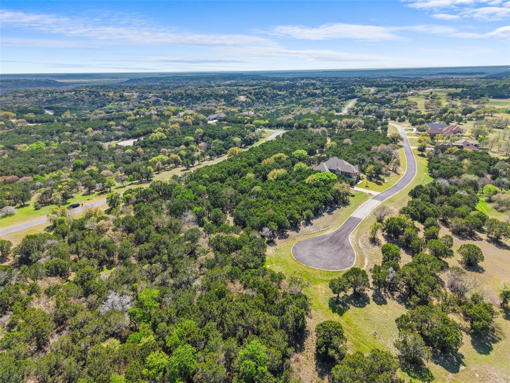 7513 St Andrews Loop Cleburne, TX 76033 - Photo 2 of 5 an aerial view of residential houses with outdoor space