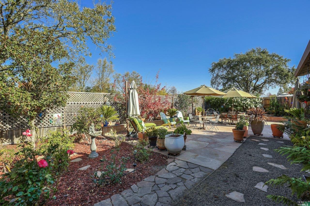 a view of a patio with couches and table and chairs and potted plants