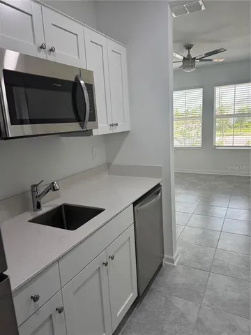 a kitchen with a sink and cabinets