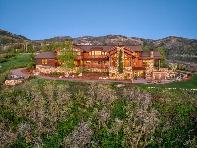 an aerial view of residential houses with outdoor space and mountain view