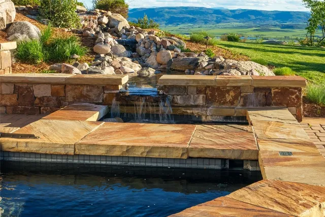 a view of swimming pool with a lounge chairs