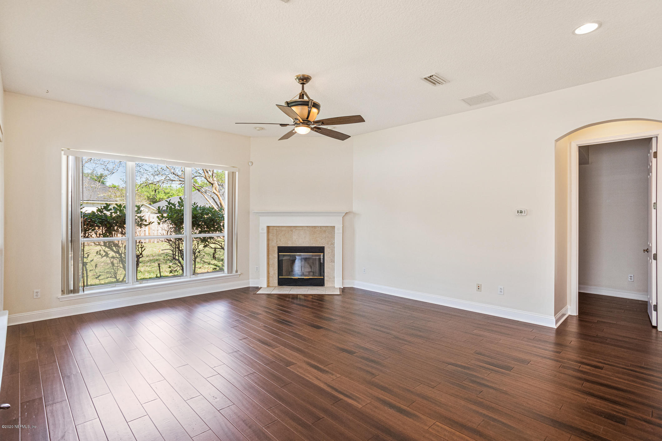 2021 Sailview Road St. Johns, FL 32259 - Photo 12 of 45 an empty room with wooden floor chandelier fan and windows