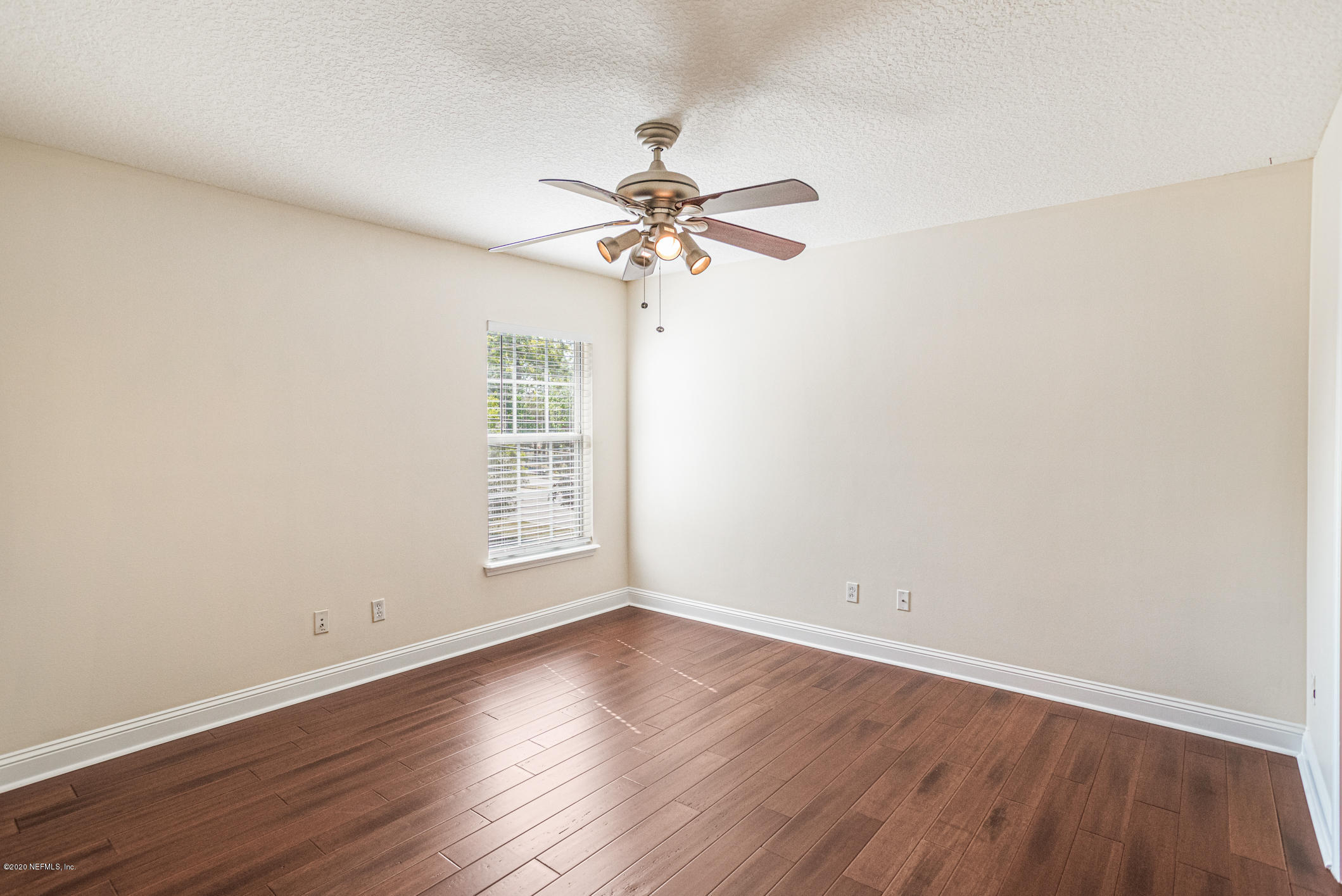 2021 Sailview Road St. Johns, FL 32259 - Photo 23 of 45 an empty room with wooden floor fan and windows