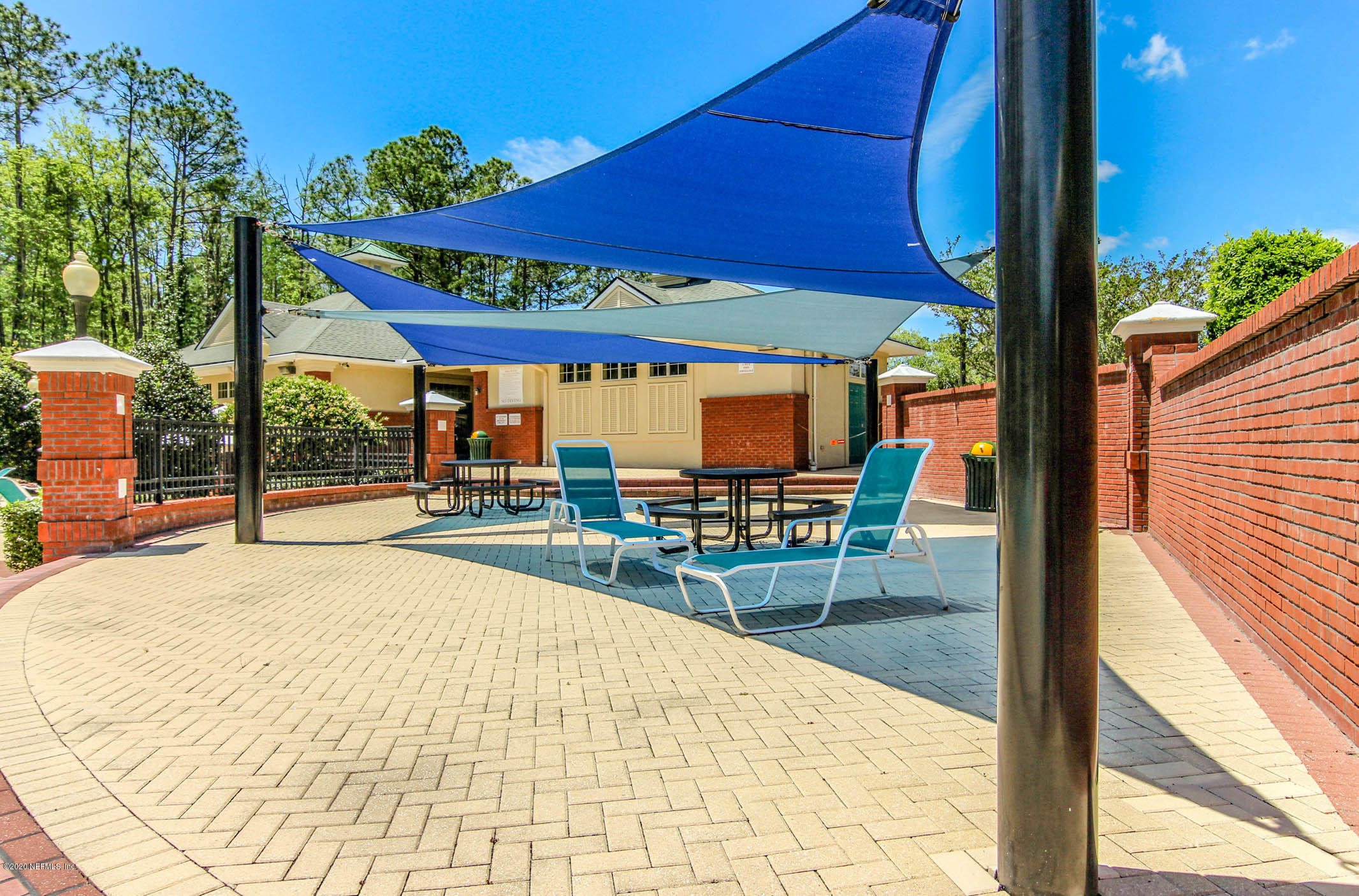 2021 Sailview Road St. Johns, FL 32259 - Photo 35 of 45 a view of a patio with a table and chairs under an umbrella
