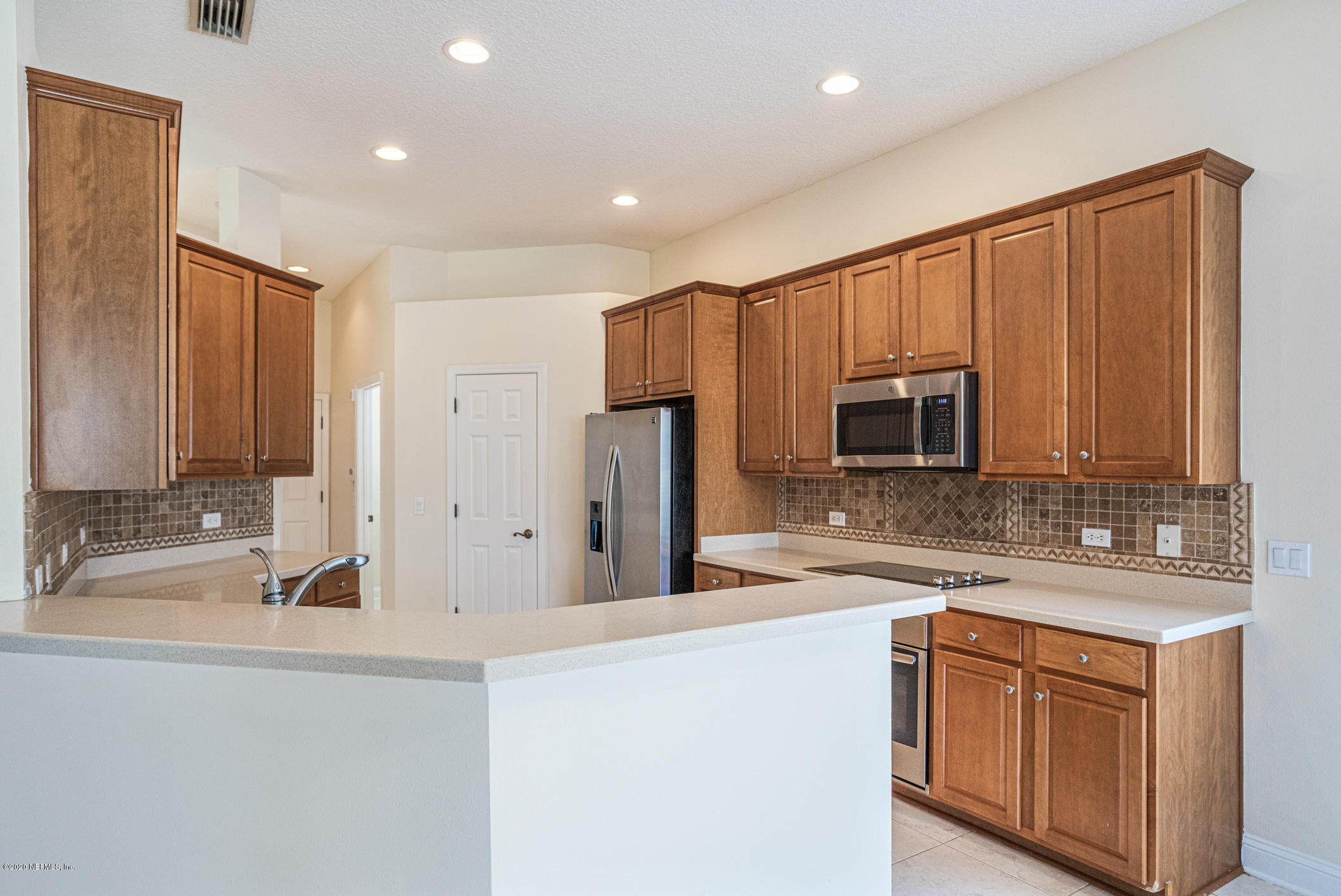 2021 Sailview Road St. Johns, FL 32259 - Photo 8 of 45 a large kitchen with kitchen island granite countertop a sink and cabinets