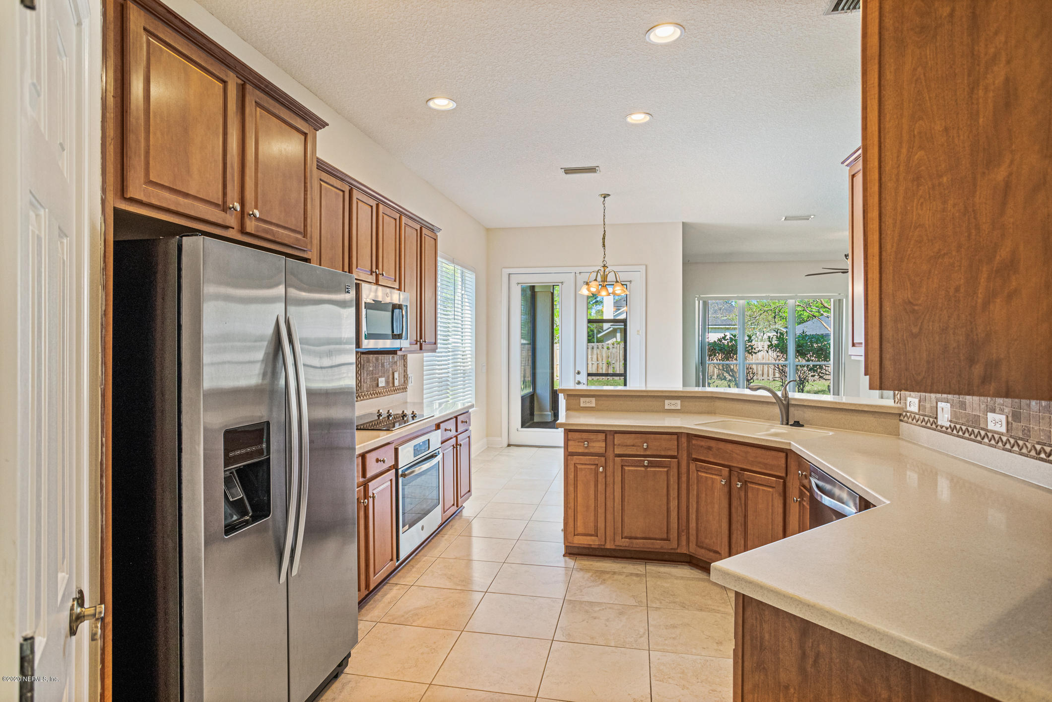 2021 Sailview Road St. Johns, FL 32259 - Photo 10 of 45 a kitchen with stainless steel appliances granite countertop a refrigerator and a sink