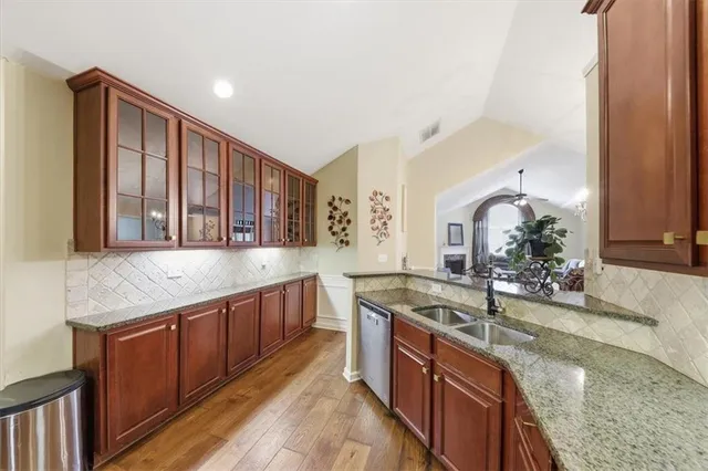 a kitchen with stainless steel appliances granite countertop a refrigerator and a sink