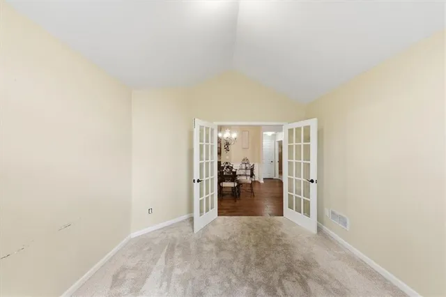a bathroom with a granite countertop toilet sink and mirror