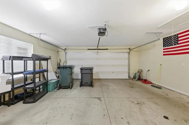 a view of a dining room and livingroom with furniture wooden floor a chandelier