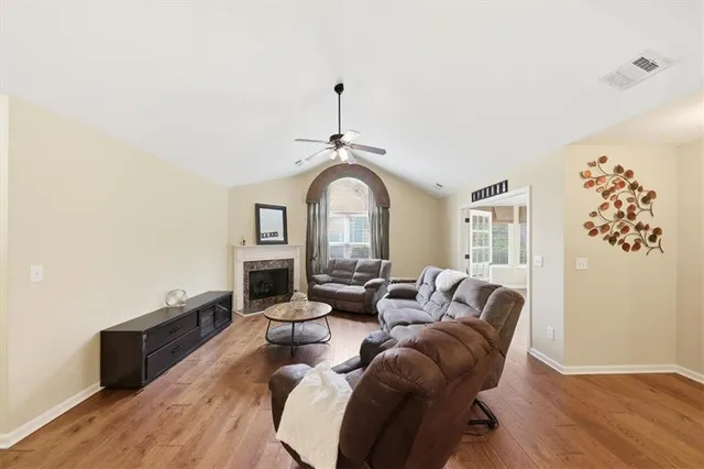 a living room with furniture a fireplace and white walls