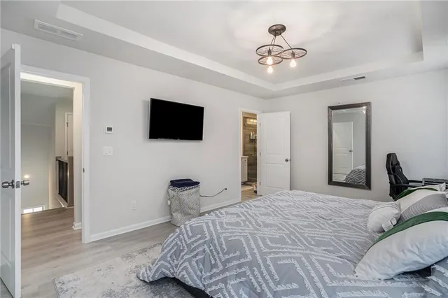 a bedroom with a bed and a chandelier