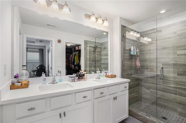 a bathroom with a shower sink and mirror