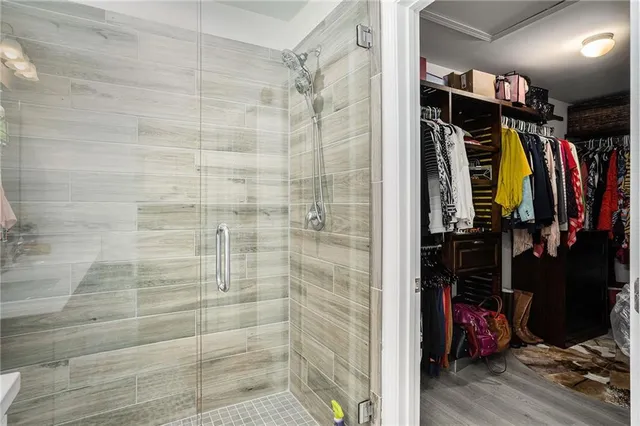a view of walk in closet with clothes and shoes
