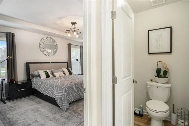 a bedroom with a bed and painting on the wall