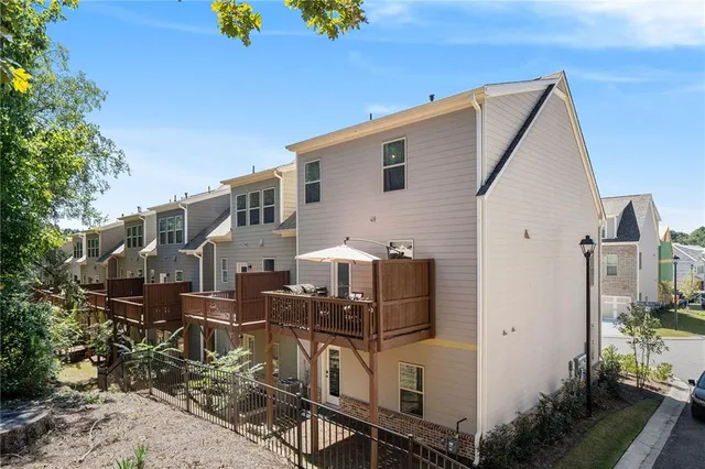 a view of a house with wooden fence