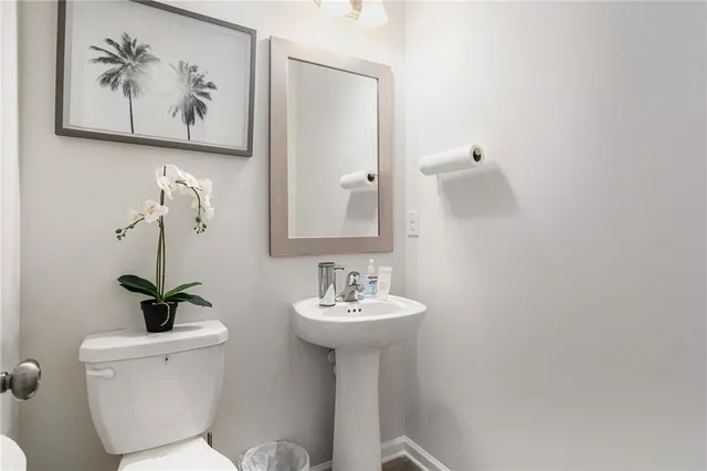 a bathroom with a sink a mirror and a toilet
