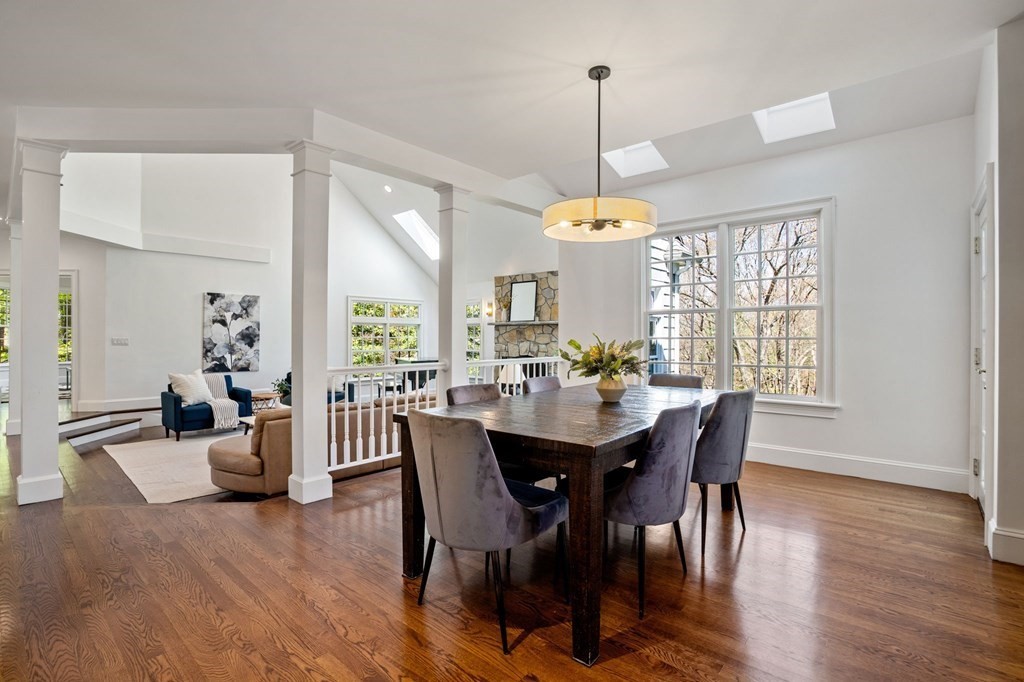 10 Forest Hill Road Wayland, MA 01778 - Photo 12 of 41 a view of a dining room and livingroom with furniture wooden floor a chandelier