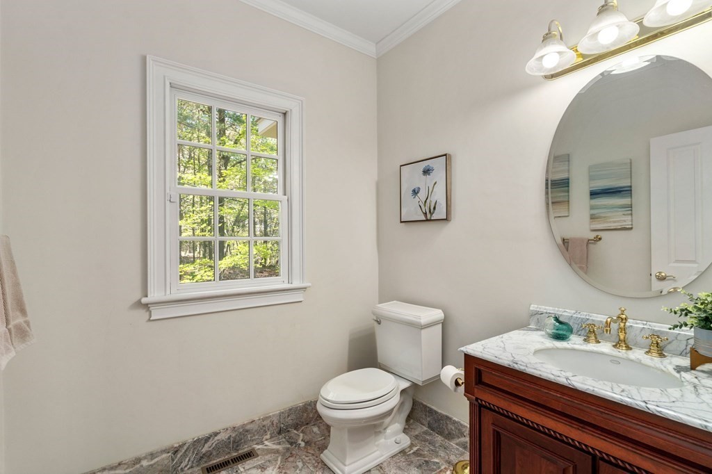 10 Forest Hill Road Wayland, MA 01778 - Photo 21 of 41 a bathroom with a granite countertop toilet sink and mirror