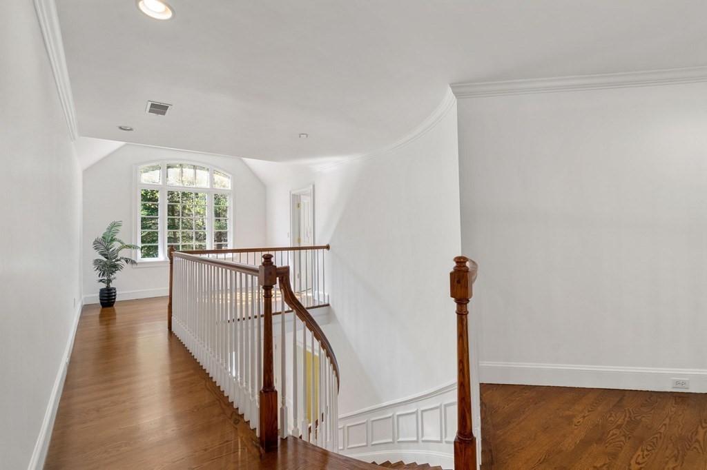 10 Forest Hill Road Wayland, MA 01778 - Photo 22 of 41 a view of a hallway with wooden floor and staircase