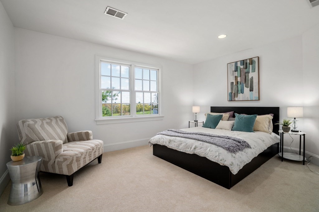 10 Forest Hill Road Wayland, MA 01778 - Photo 31 of 41 a spacious bedroom with a bed and a couch