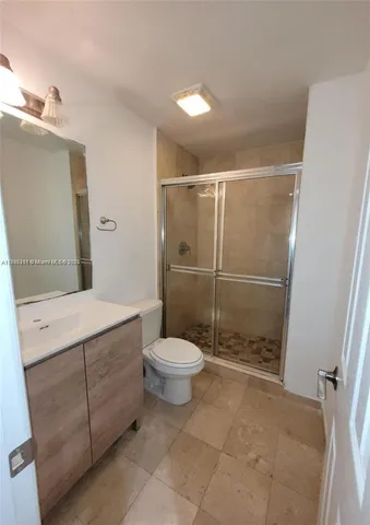 a bathroom with a toilet sink and shower