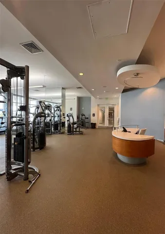 a room with gym equipment and a view of living room