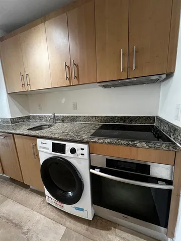 a close view of a stove top oven and cabinets