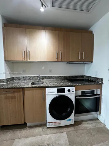 a kitchen with a stove and a sink