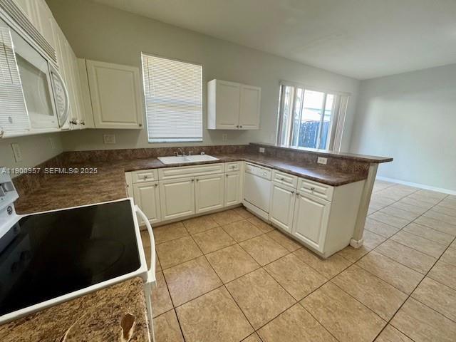 12925 Southwest 134th Terrace Miami, FL 33186 - Photo 10 of 26 a kitchen with stainless steel appliances granite countertop a stove a sink and a microwave