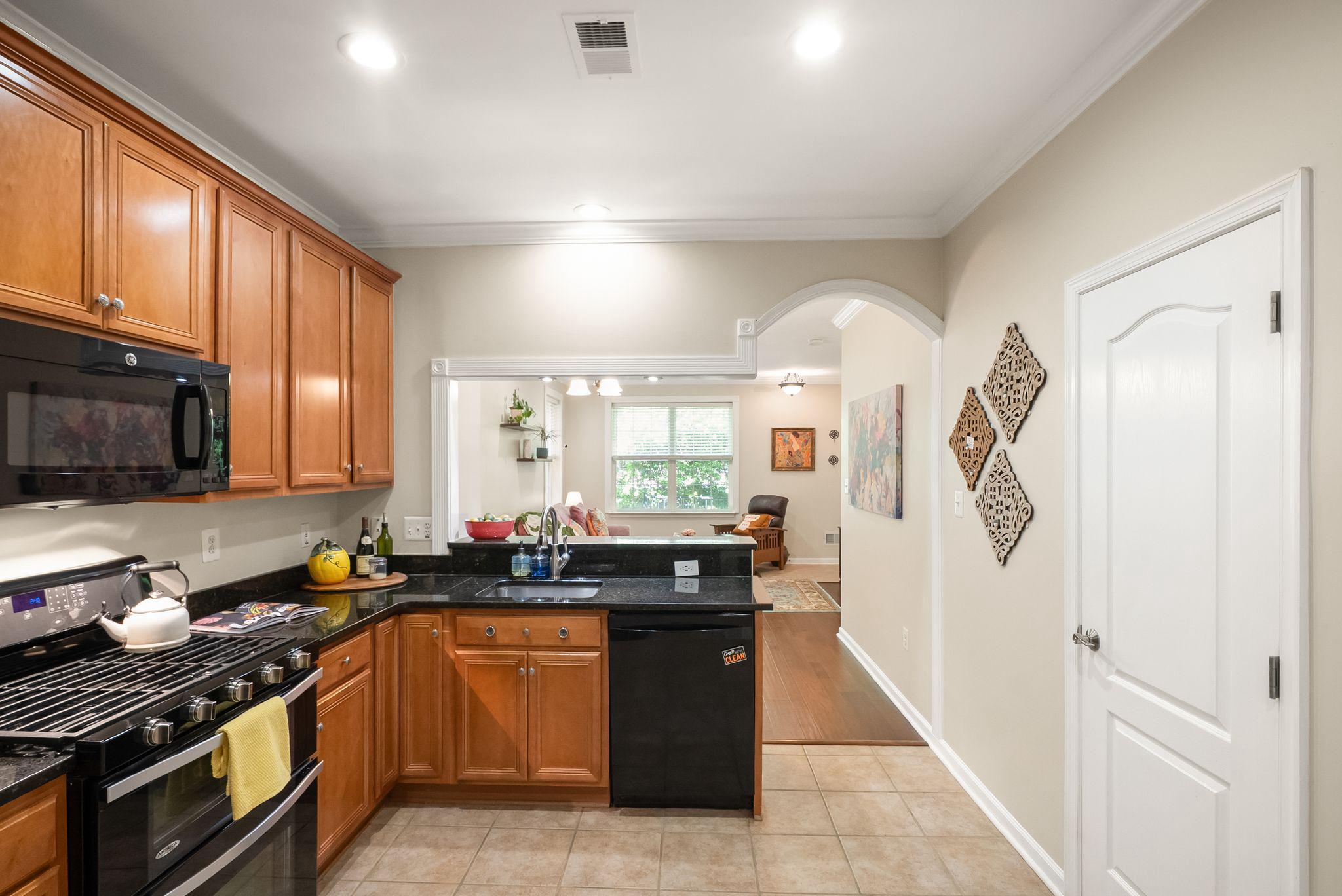 12414 A Liberty Bridge Road Fairfax, VA 22033 - Photo 10 of 38 a kitchen with stainless steel appliances granite countertop a stove a sink and a microwave