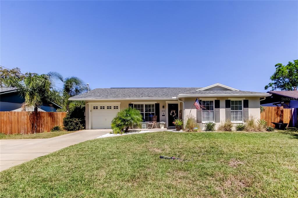 2115 West Barclay Road Tampa, FL 33612 - Photo 1 of 1 a front view of a house with a yard porch and outdoor seating