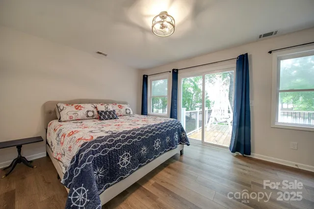 a bedroom with a large bed and a large window