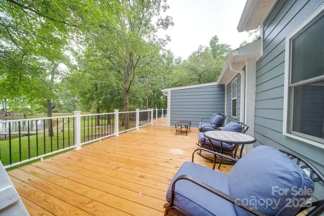 a view of a roof deck with wooden floor and outdoor seating