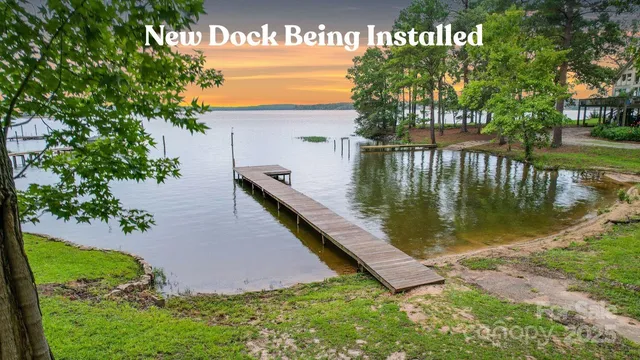 a view of swimming pool with a garden and deck