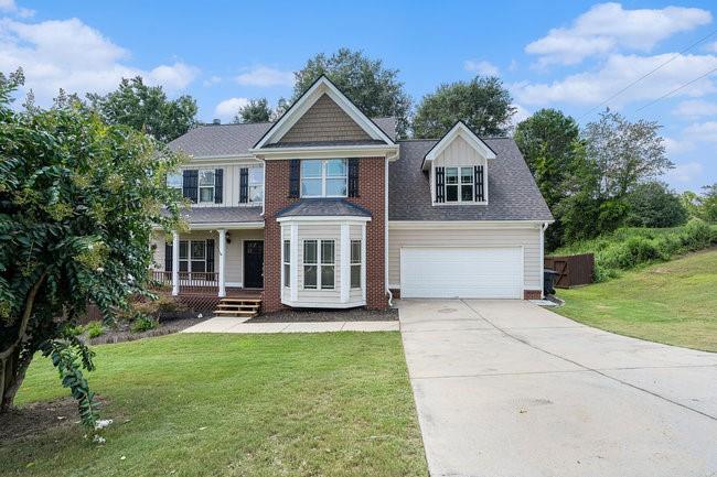 34 Johns Way Commerce, GA 30529 - Photo 1 of 1 a front view of a house with garden