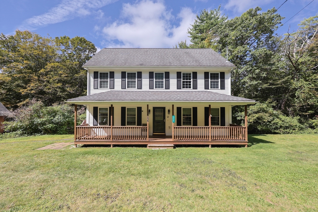 a front view of a house with a yard table and chairs