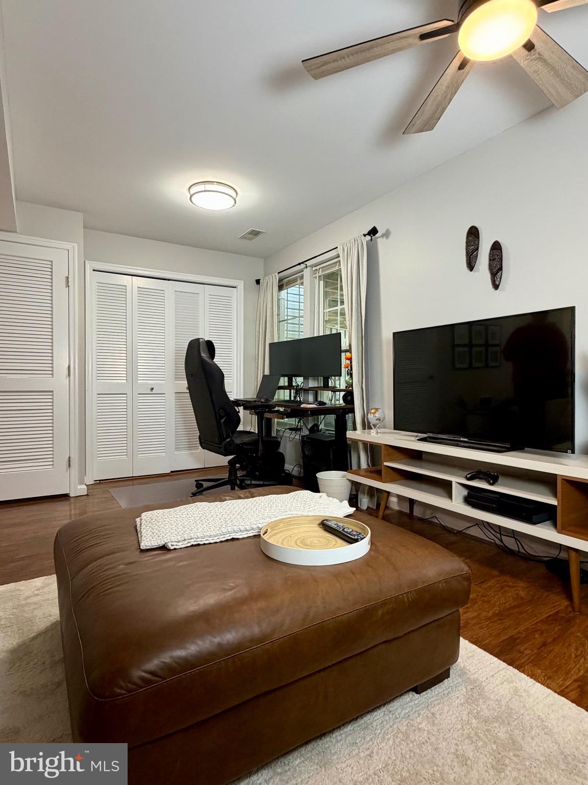 7108 Wheeling Way Gainesville, VA 20155 - Photo 8 of 45 a living room with furniture and a flat screen tv