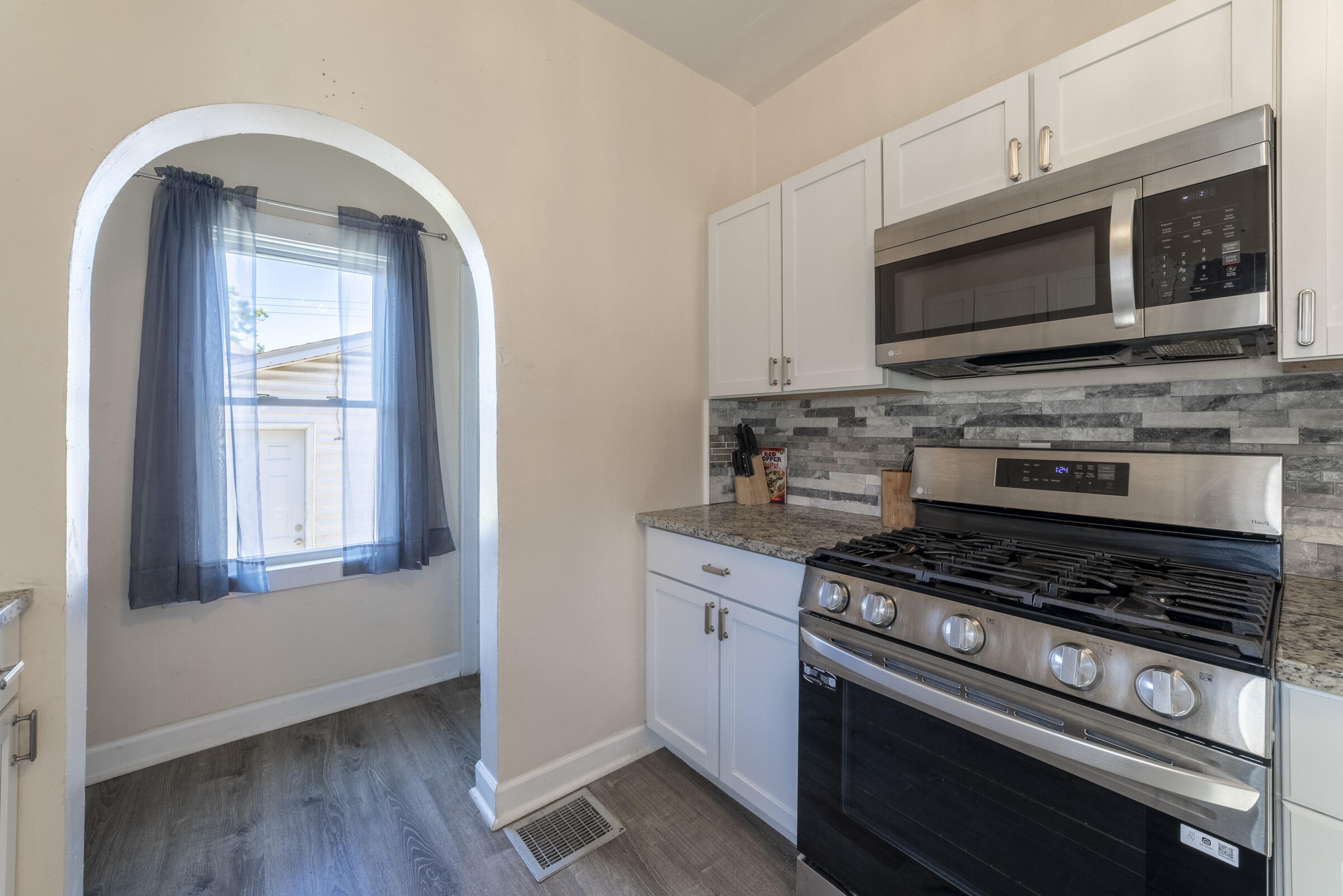 314 Cleveland Street Gary, IN 46404 - Photo 18 of 60 a kitchen with stainless steel appliances a stove a microwave and sink