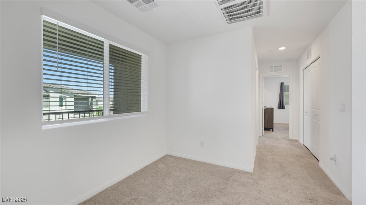 12346 Indigo Montage Road, Unit 4 Las Vegas, NV 89183 - Photo 15 of 27 Unfurnished room with light colored carpet and recessed lighting
